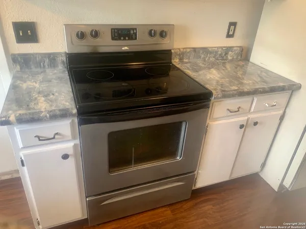 a stove top oven sitting inside of a kitchen