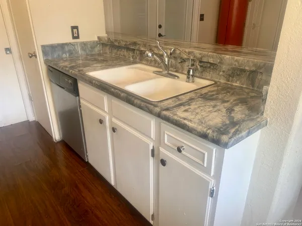 a bathroom with a granite countertop sink and a mirror