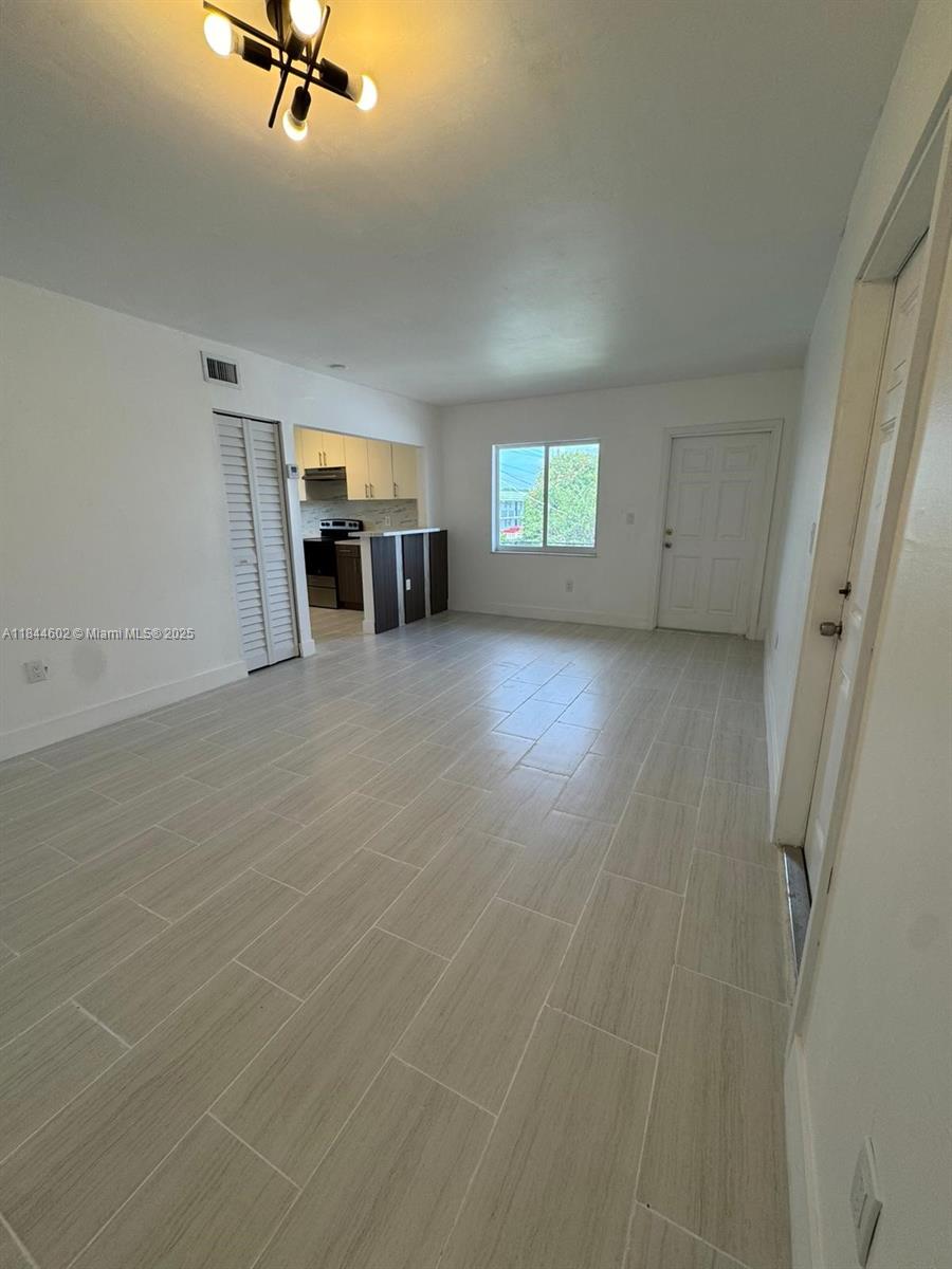 800 Northwest 44th Avenue, Unit 4 Miami, FL 33126 - Photo 1 of 9 a view of a livingroom with a fireplace and window