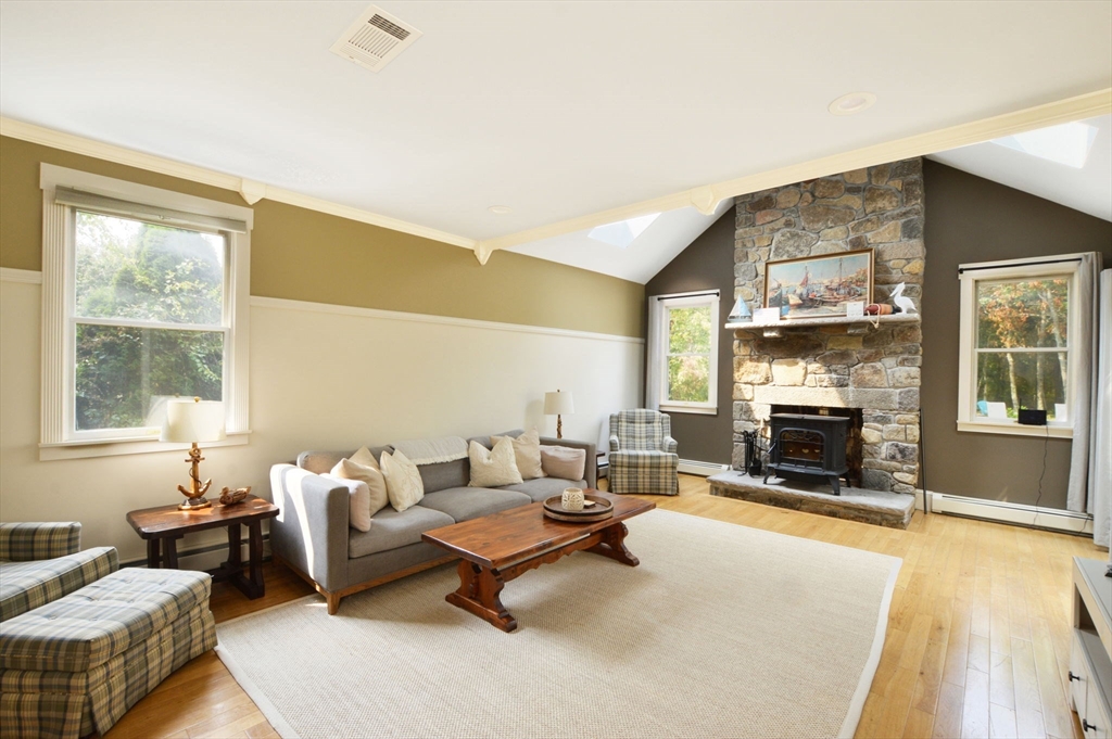 48 Tara Terrace Bourne, MA 02532 - Photo 11 of 33 a living room with furniture window and a fireplace