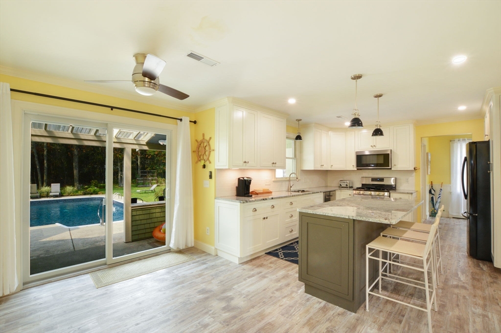 48 Tara Terrace Bourne, MA 02532 - Photo 16 of 33 a kitchen with stainless steel appliances kitchen island granite countertop a sink and cabinets