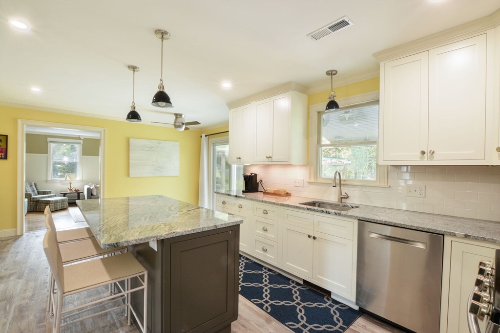 48 Tara Terrace Bourne, MA 02532 - Photo 17 of 33 a kitchen with center island table and chairs
