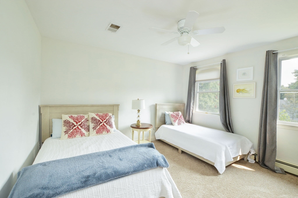 48 Tara Terrace Bourne, MA 02532 - Photo 29 of 33 a bedroom with a large bed and a chandelier