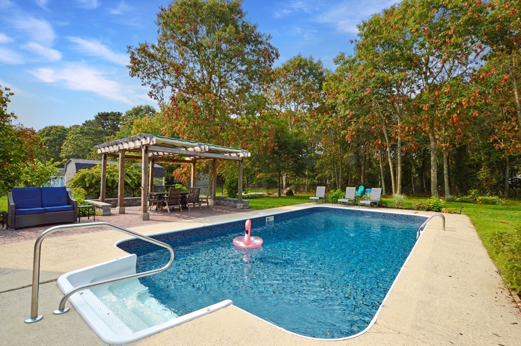 48 Tara Terrace Bourne, MA 02532 - Photo 3 of 33 a view of a swimming pool with lounge chairs in patio