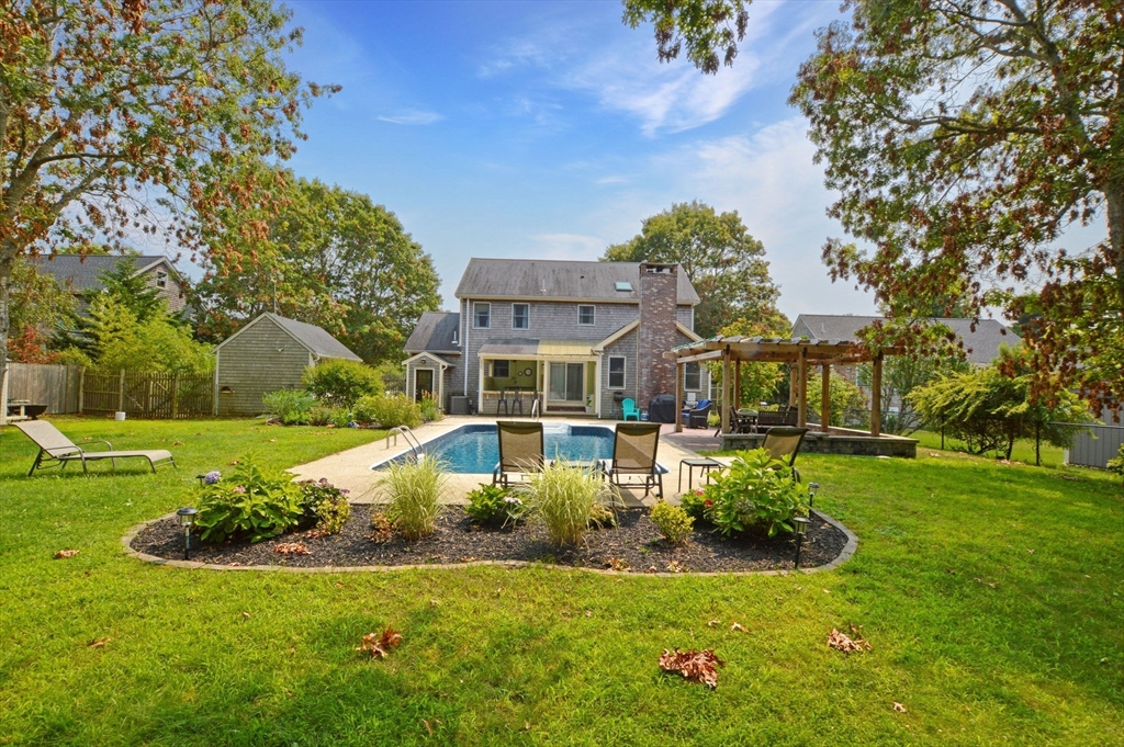 48 Tara Terrace Bourne, MA 02532 - Photo 32 of 33 a front view of a house with a yard table and chairs