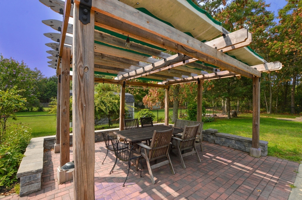 48 Tara Terrace Bourne, MA 02532 - Photo 5 of 33 a view of a patio with a table chairs and a backyard