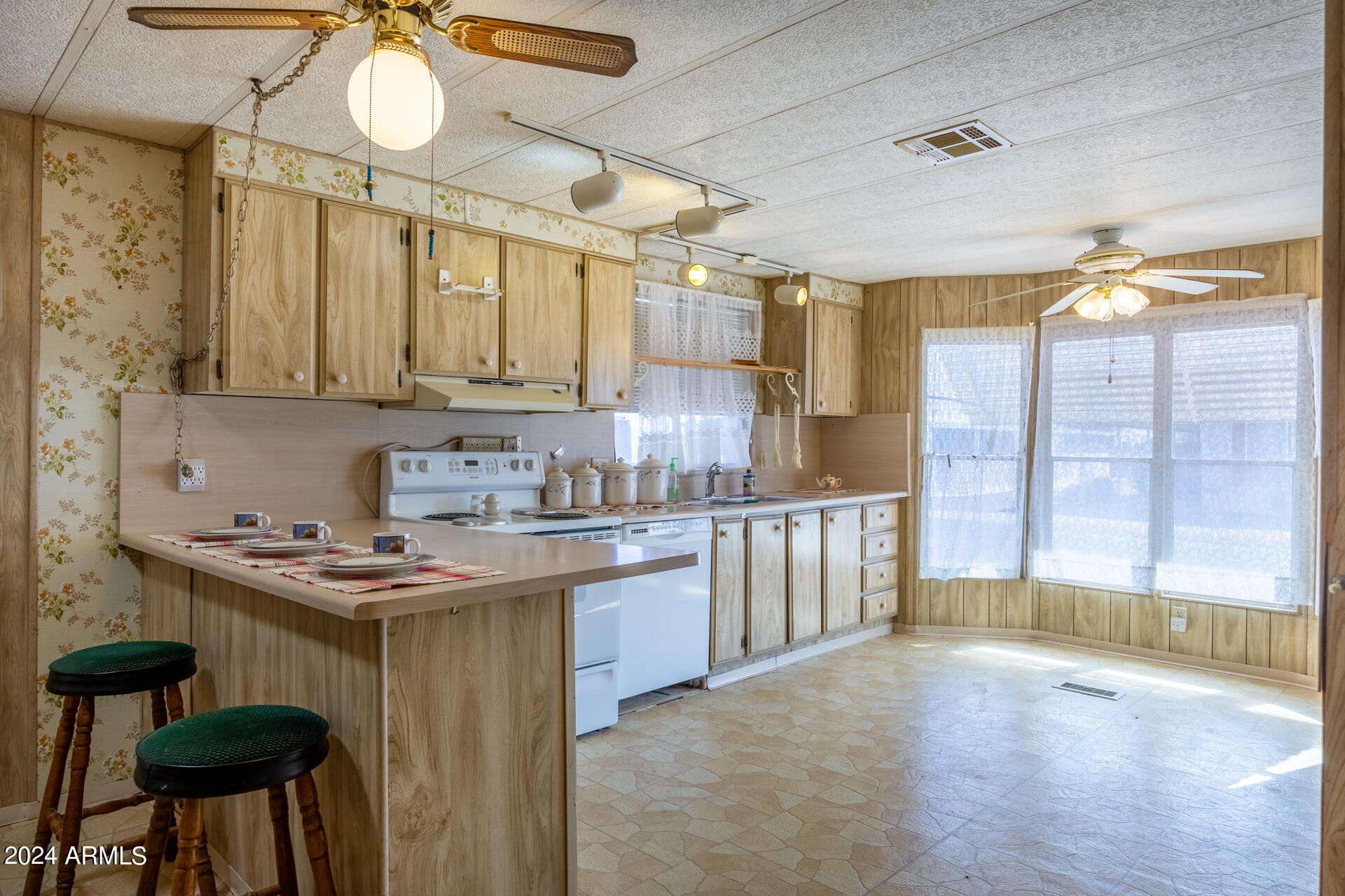 a kitchen with a sink cabinets and window
