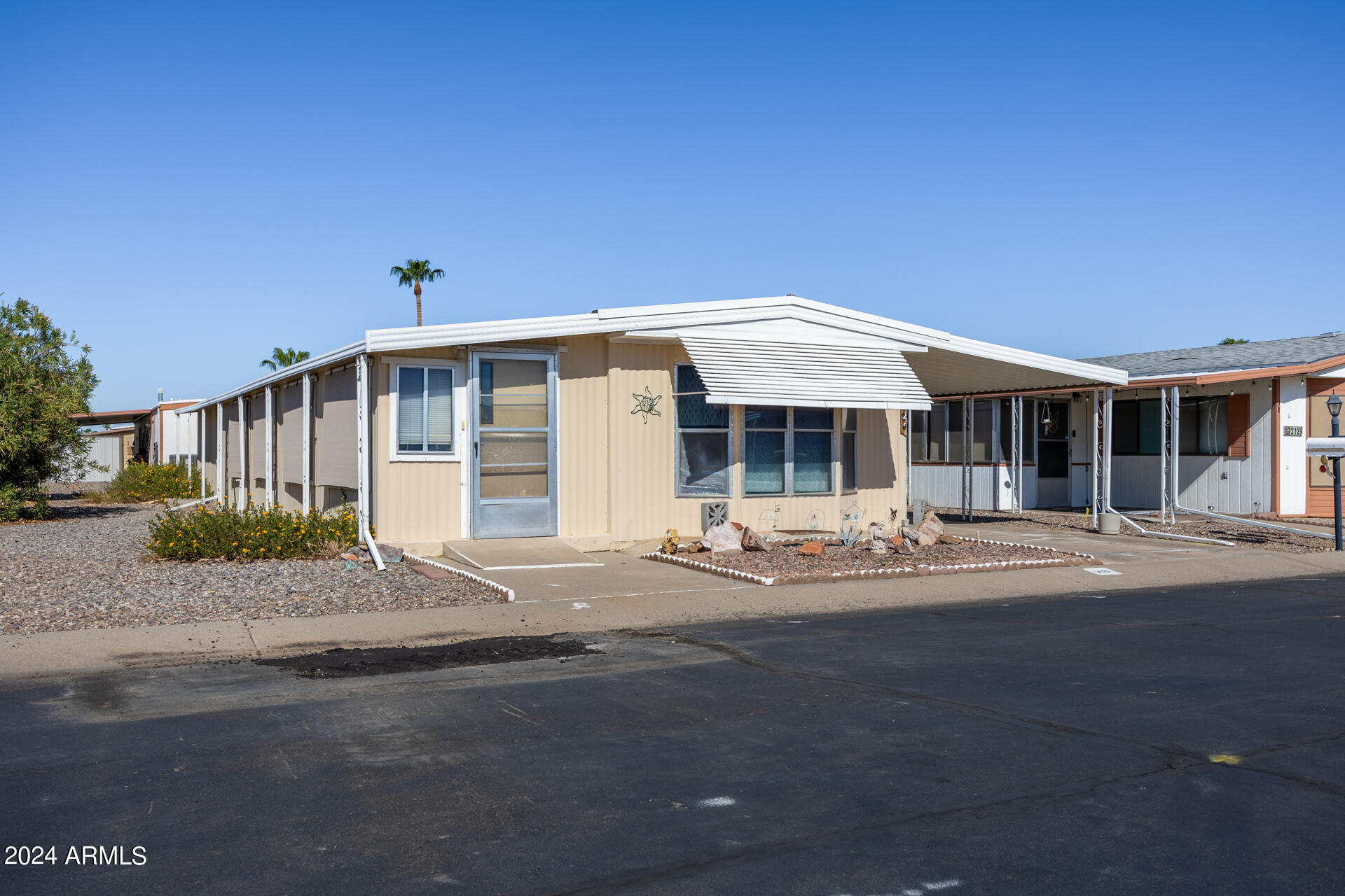 2100 North Trekell Road, Unit 148 Casa Grande, AZ 85122 - Photo 3 of 36 a front view of a house with a outdoor space