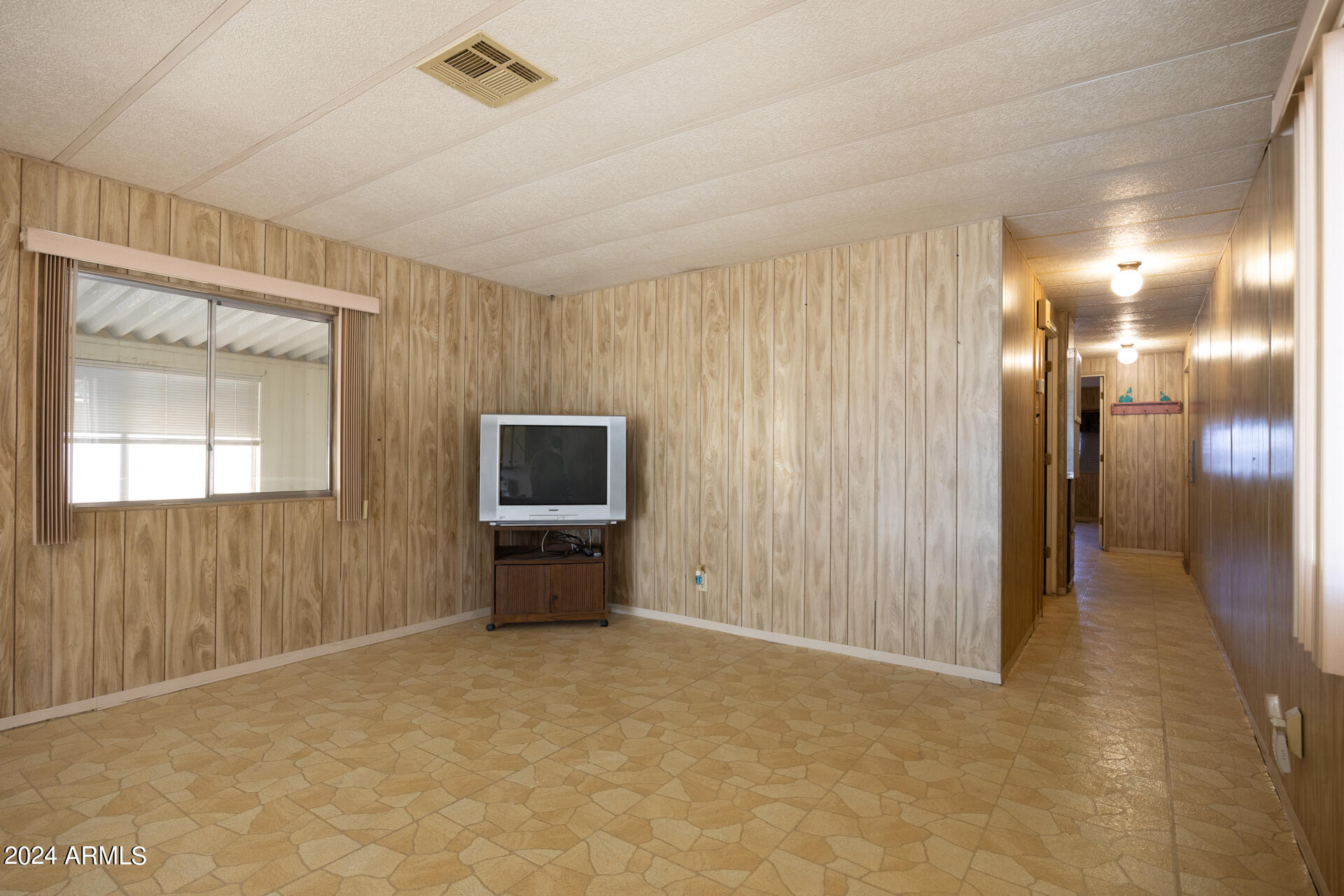 2100 North Trekell Road, Unit 148 Casa Grande, AZ 85122 - Photo 7 of 36 a view of a livingroom with furniture and a flat screen tv