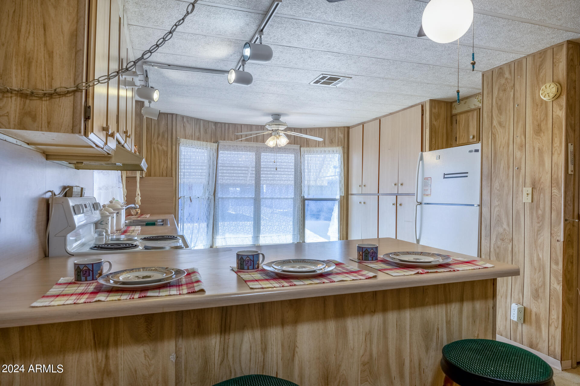 2100 North Trekell Road, Unit 148 Casa Grande, AZ 85122 - Photo 8 of 36 a kitchen with a table and a stove top oven