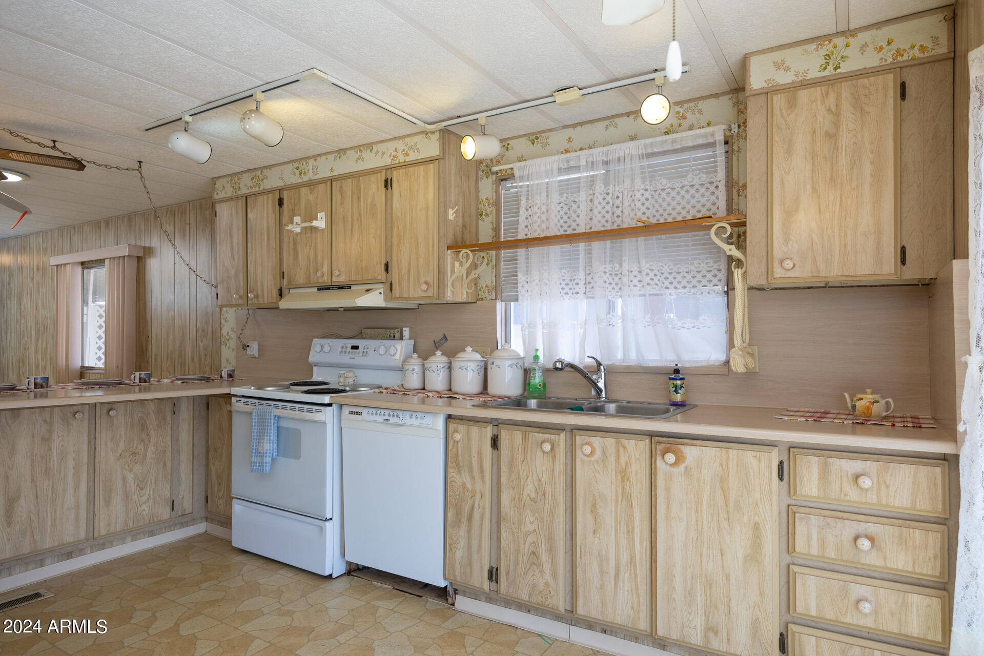 2100 North Trekell Road, Unit 148 Casa Grande, AZ 85122 - Photo 9 of 36 a kitchen with a sink stove and cabinets