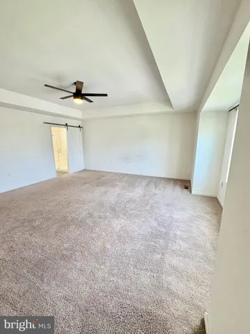 a view of a livingroom with a ceiling fan and window