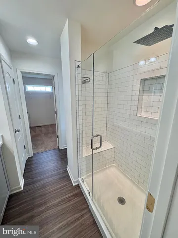 an empty room with windows and ceiling fan