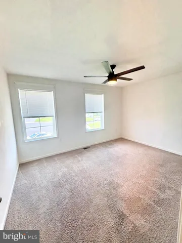 a view of room with window and ceiling fan