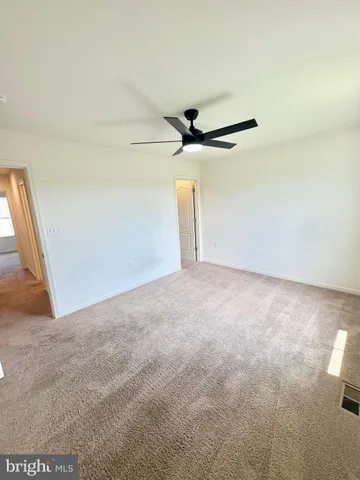 a view of an empty room and a window