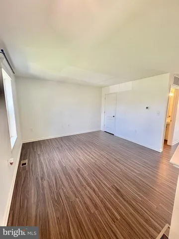 a large kitchen with stainless steel appliances a large counter top a stove a sink dishwasher and a refrigerator