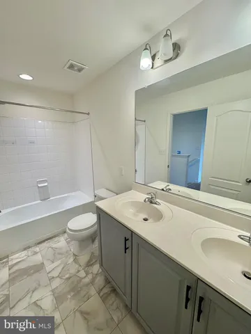 a kitchen with stainless steel appliances wooden floors and view living room