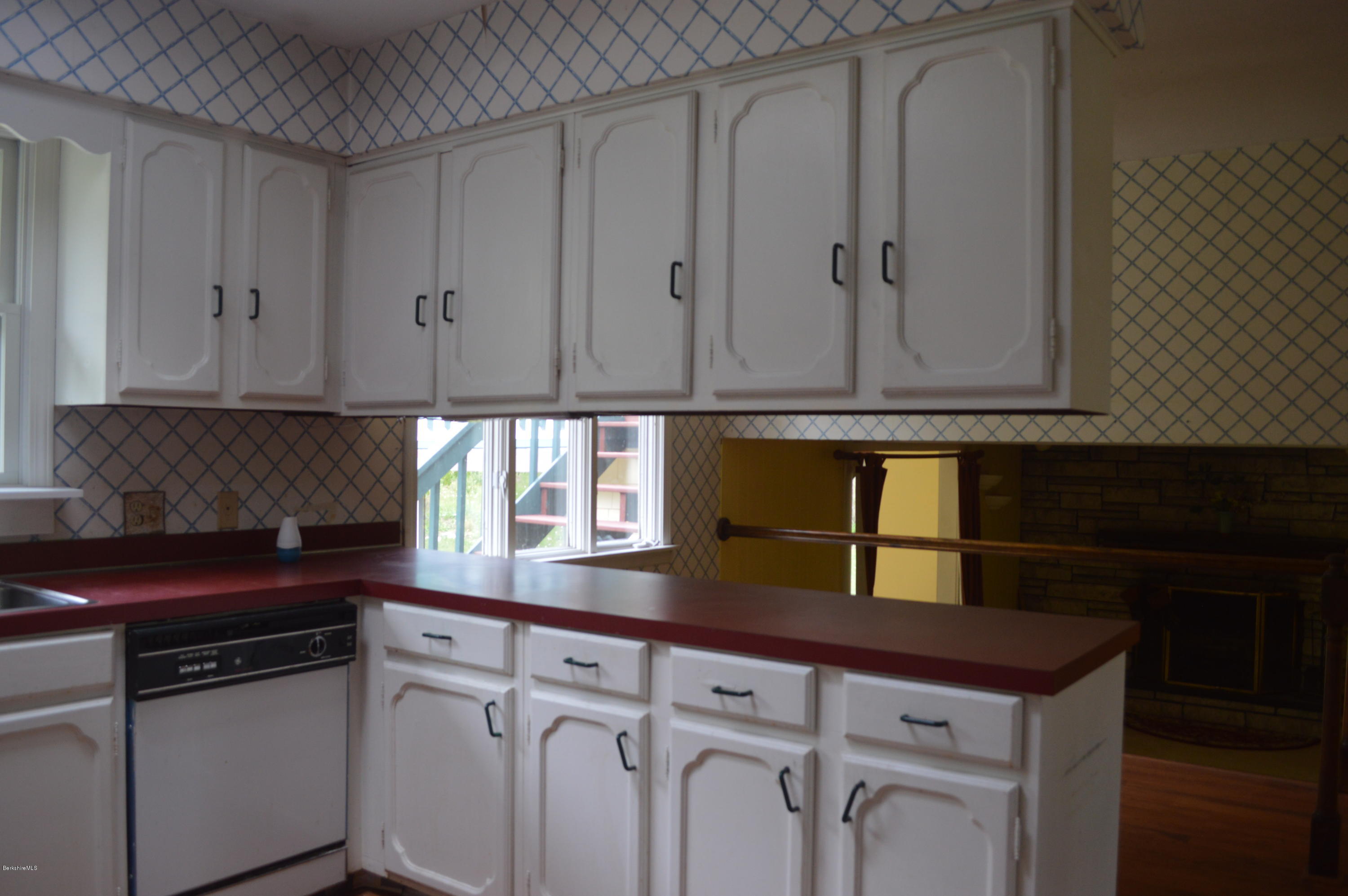 2131 Dublin Road Richmond, MA 01254 - Photo 7 of 51 a kitchen with granite countertop white cabinets and black appliances