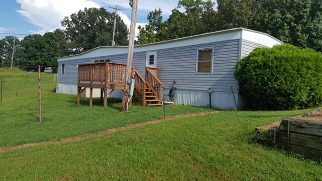 4235-4237 Jordantown Road Vinton, VA 24179 - Photo 2 of 20 a view of a backyard with table and chairs potted plants and large tree