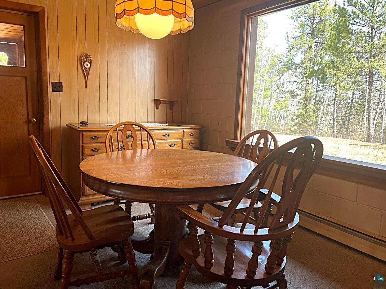 1480 Maijala Road Ely, MN 55731 - Photo 16 of 58 Dining area featuring wood-paneled walls and a large picture window