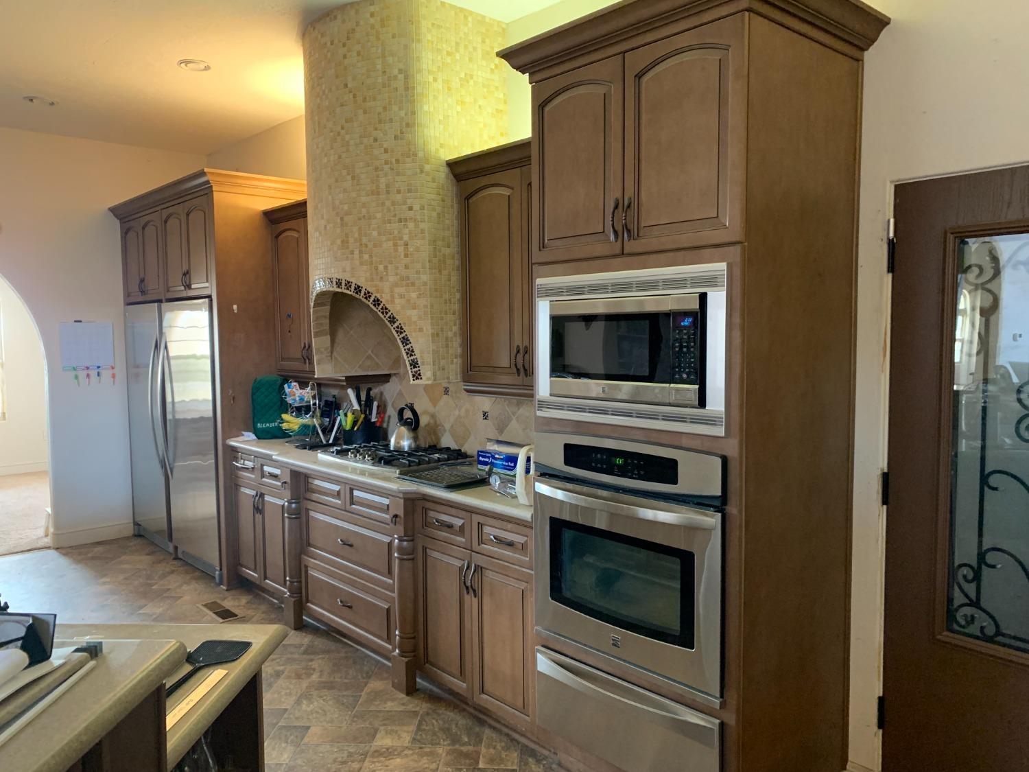 1662 South Alta Avenue Reedley, CA 93654 - Photo 18 of 30 a kitchen with stainless steel appliances granite countertop a stove microwave and refrigerator
