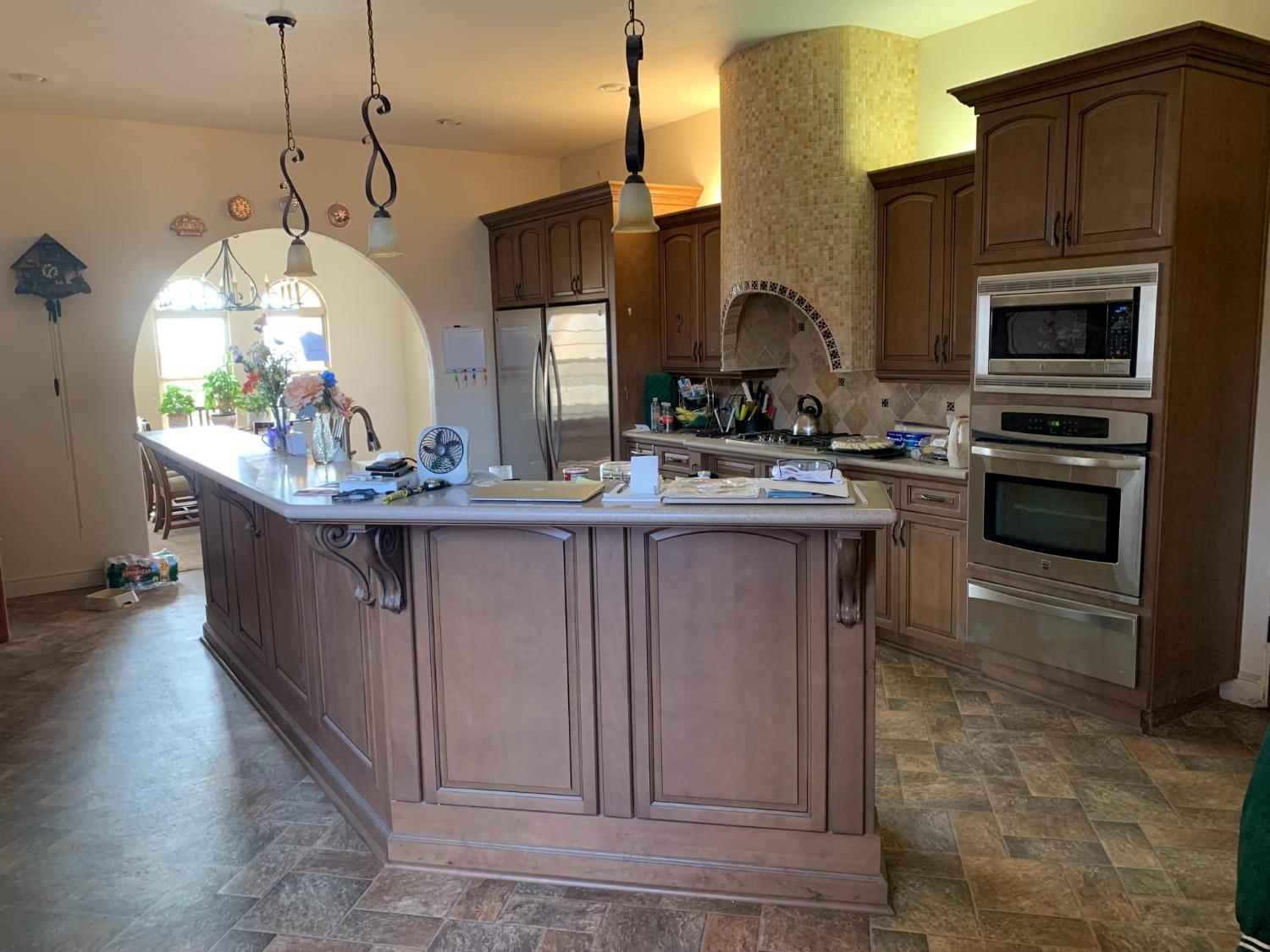 1662 South Alta Avenue Reedley, CA 93654 - Photo 19 of 30 a kitchen with stainless steel appliances granite countertop a sink a stove and a wooden floors