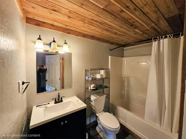 a bathroom with a sink a toilet a mirror and shower