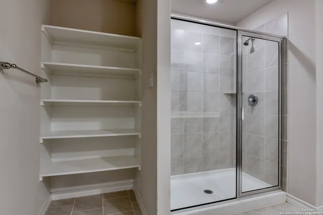 a bathroom with a glass shower door