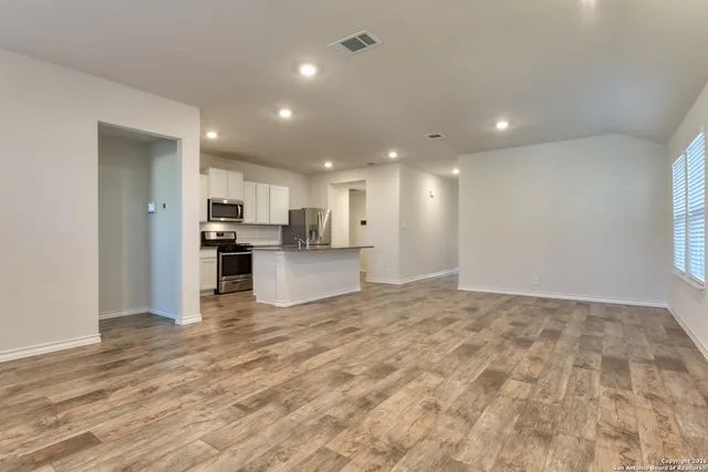a view of kitchen with refrigerator sink and stove