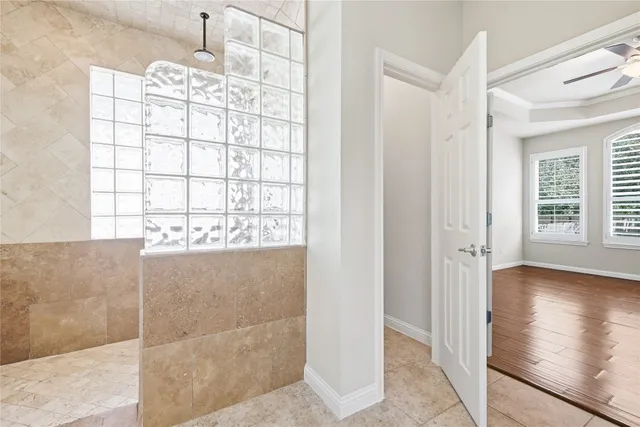a spacious bathroom with a double vanity sink a large mirror and a shower