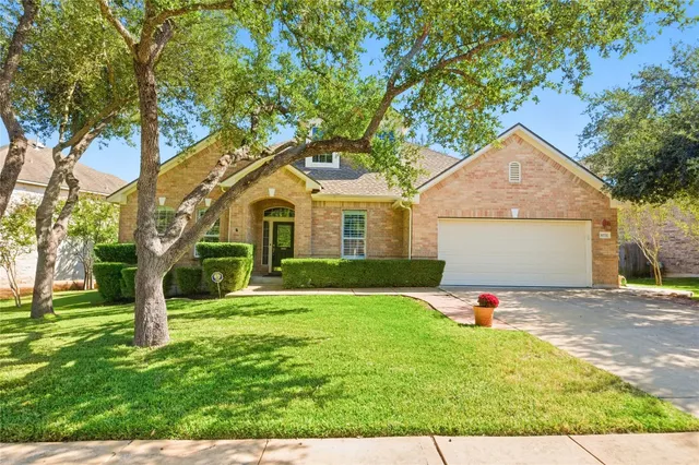 a front view of a house with a yard