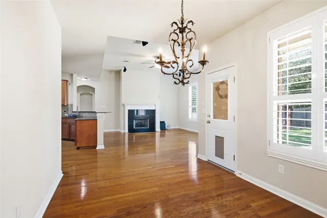 a view of a livingroom with a kitchen and a window