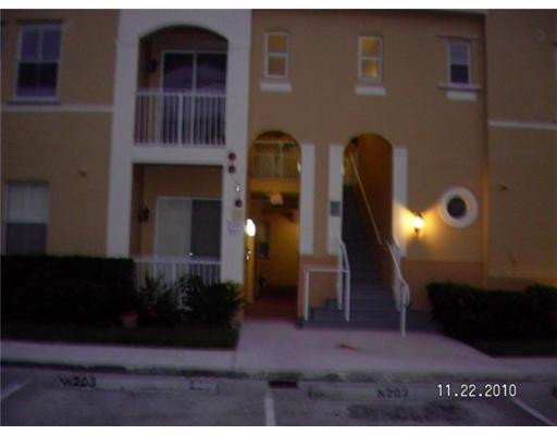 4445 Southwest 160th Avenue, Unit 101 Miramar, FL 33027 - Photo 1 of 8 a front view of a house with a yard