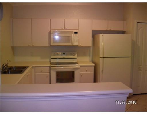 4445 Southwest 160th Avenue, Unit 101 Miramar, FL 33027 - Photo 2 of 8 a kitchen with a refrigerator and a stove