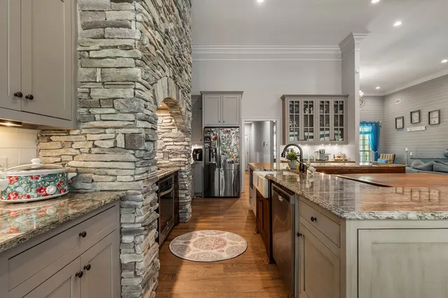 a kitchen with stainless steel appliances granite countertop a sink stove and cabinets