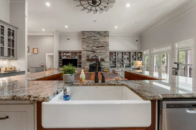 a large kitchen with granite countertop a sink and a counter top space