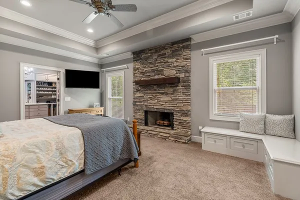 a spacious bedroom with a large bed and a fireplace