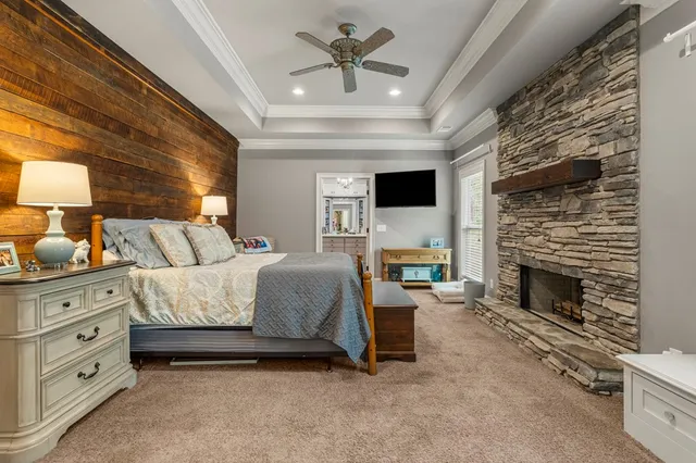 a spacious bedroom with a bed and a fireplace