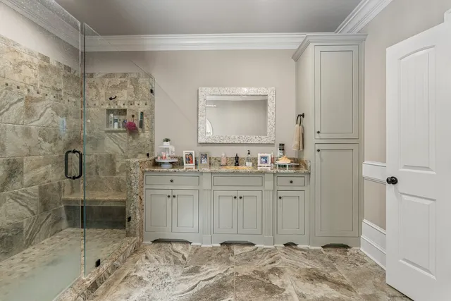 a spacious bathroom with a shower sink and mirror