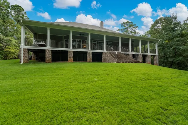 a view of an house with backyard space and balcony