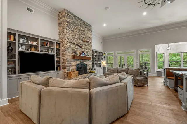 a living room with furniture flat screen tv and a fireplace