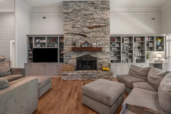 a living room with furniture large window and a fireplace
