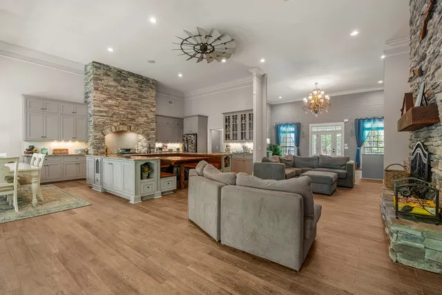 a living room with furniture and a chandelier