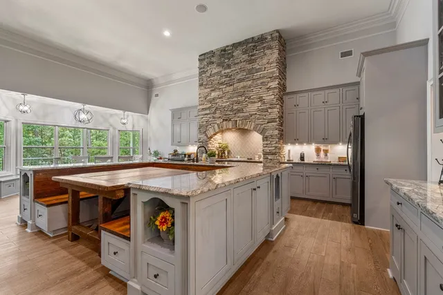 a kitchen with stainless steel appliances granite countertop a sink and a stove