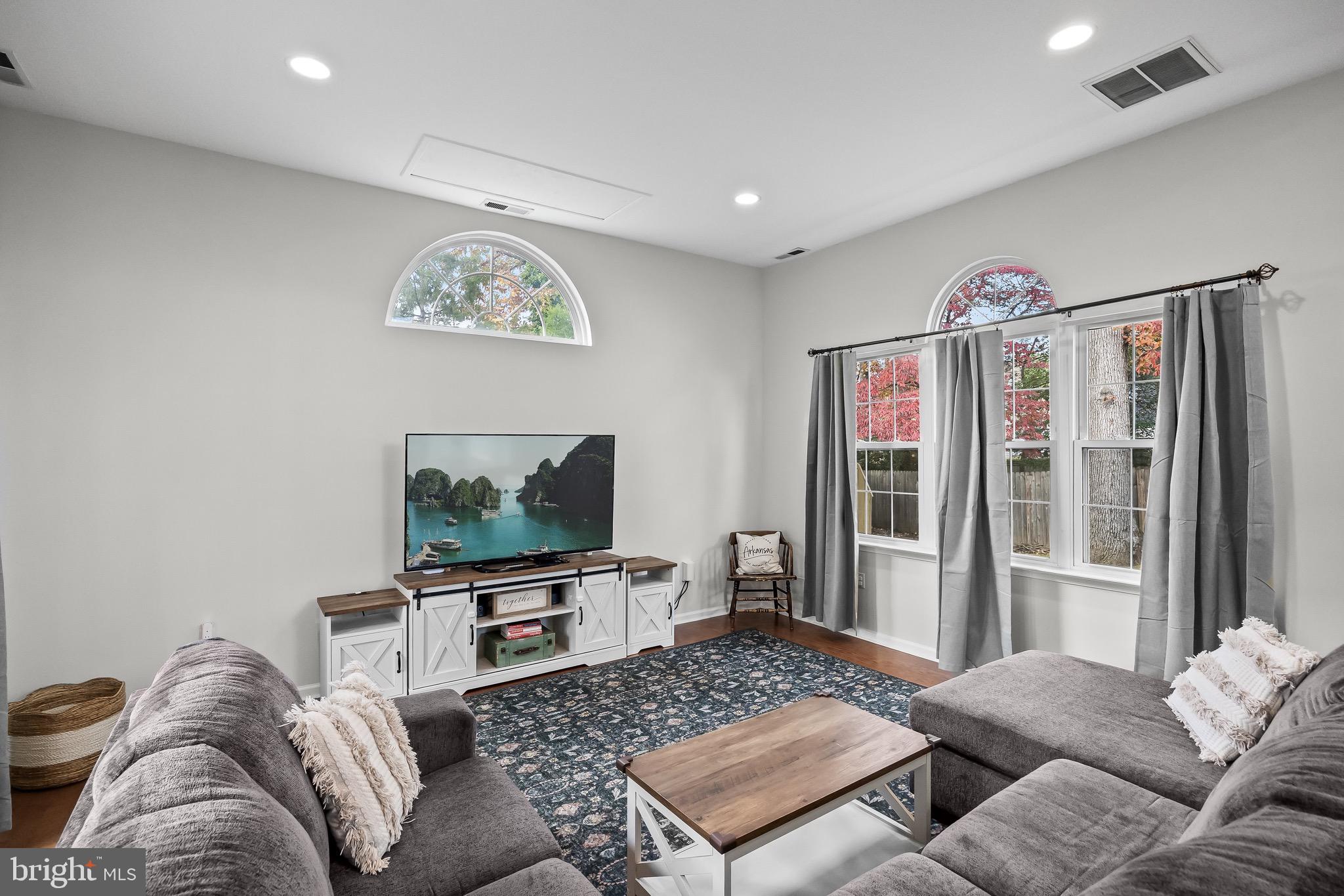 5 Hampton Court Mount Laurel, NJ 08054 - Photo 11 of 46 a living room with furniture a large window and a flat screen tv