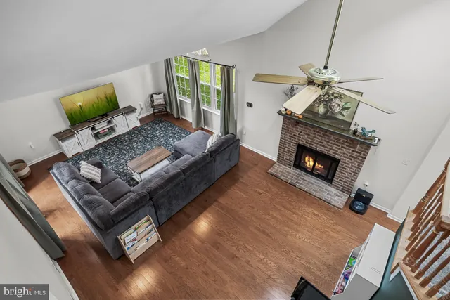 a dining room with furniture a chandelier and wooden floor