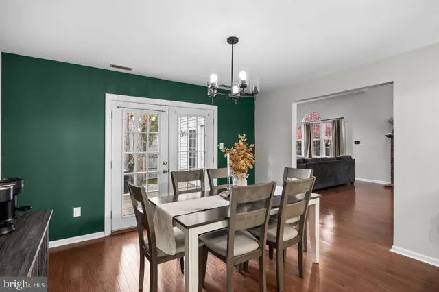 a kitchen with a stove a sink a dining table and chairs