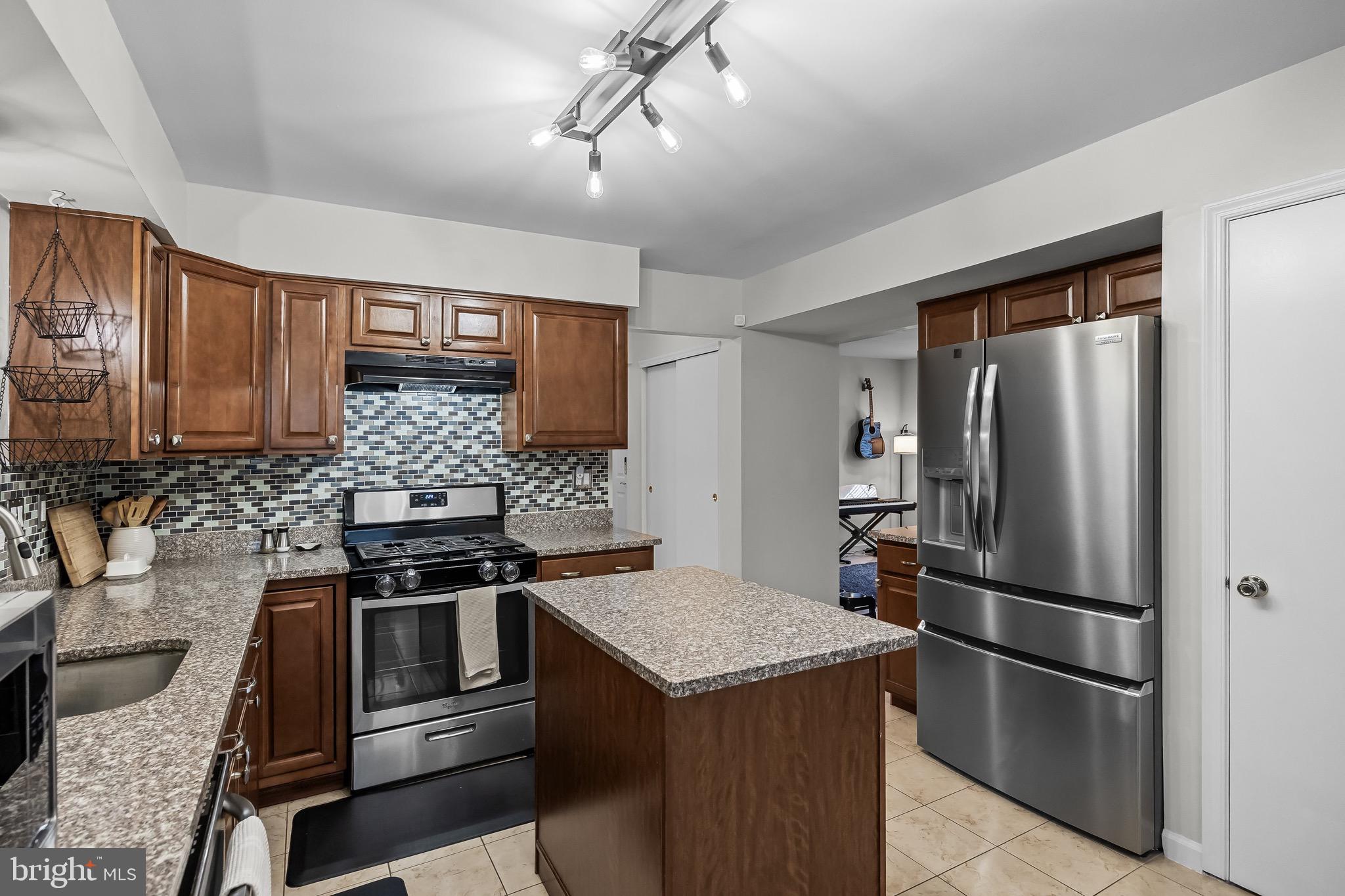 5 Hampton Court Mount Laurel, NJ 08054 - Photo 22 of 46 a kitchen with stainless steel appliances granite countertop a stove refrigerator and microwave