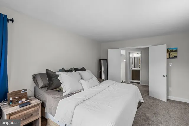 a bedroom with a large bed and a window