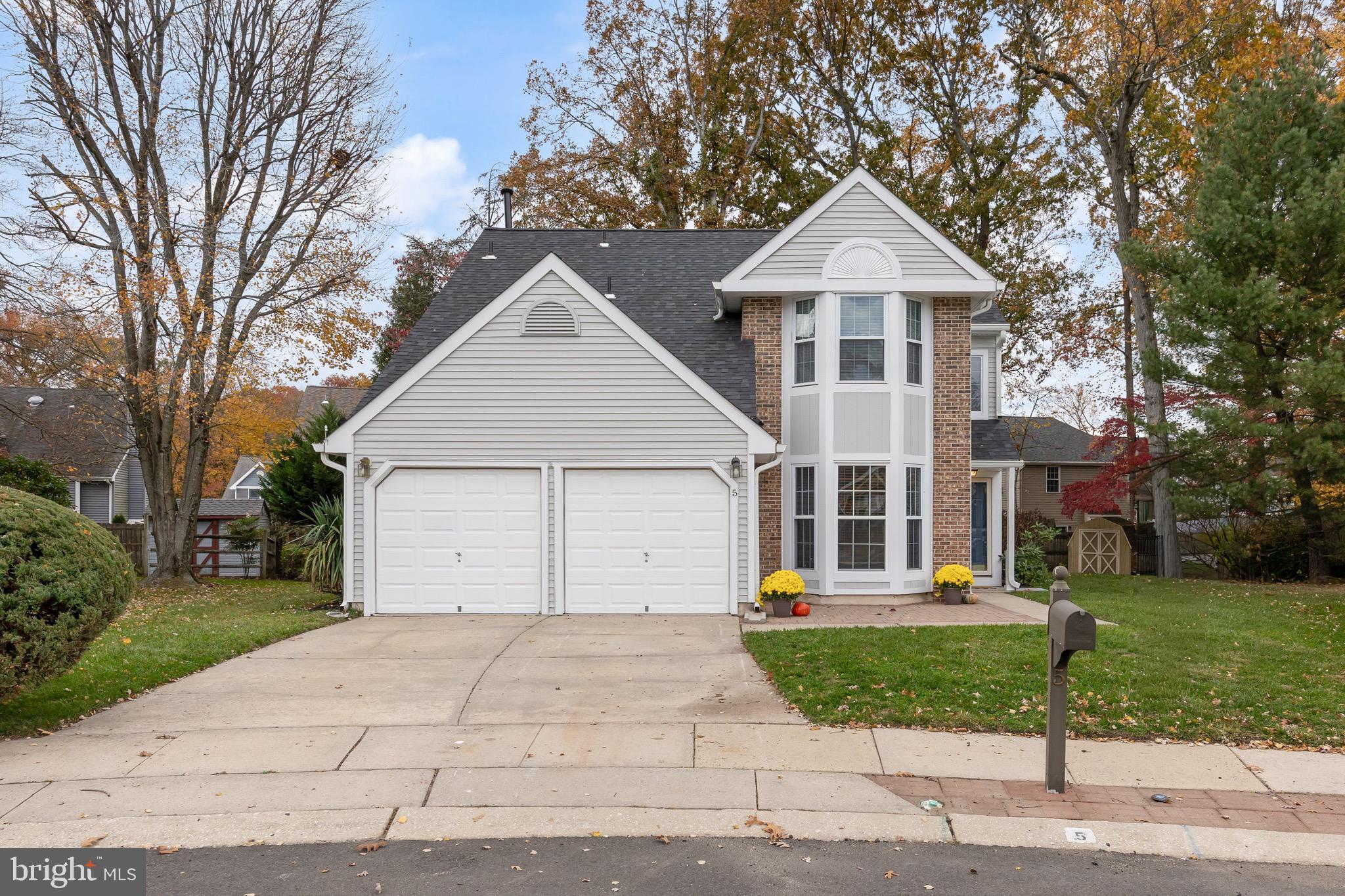 5 Hampton Court Mount Laurel, NJ 08054 - Photo 3 of 46 a front view of a house with a yard and garage